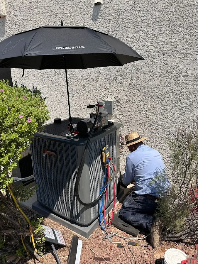 HVAC technician performing outdoor AC maintenance in Stanwood